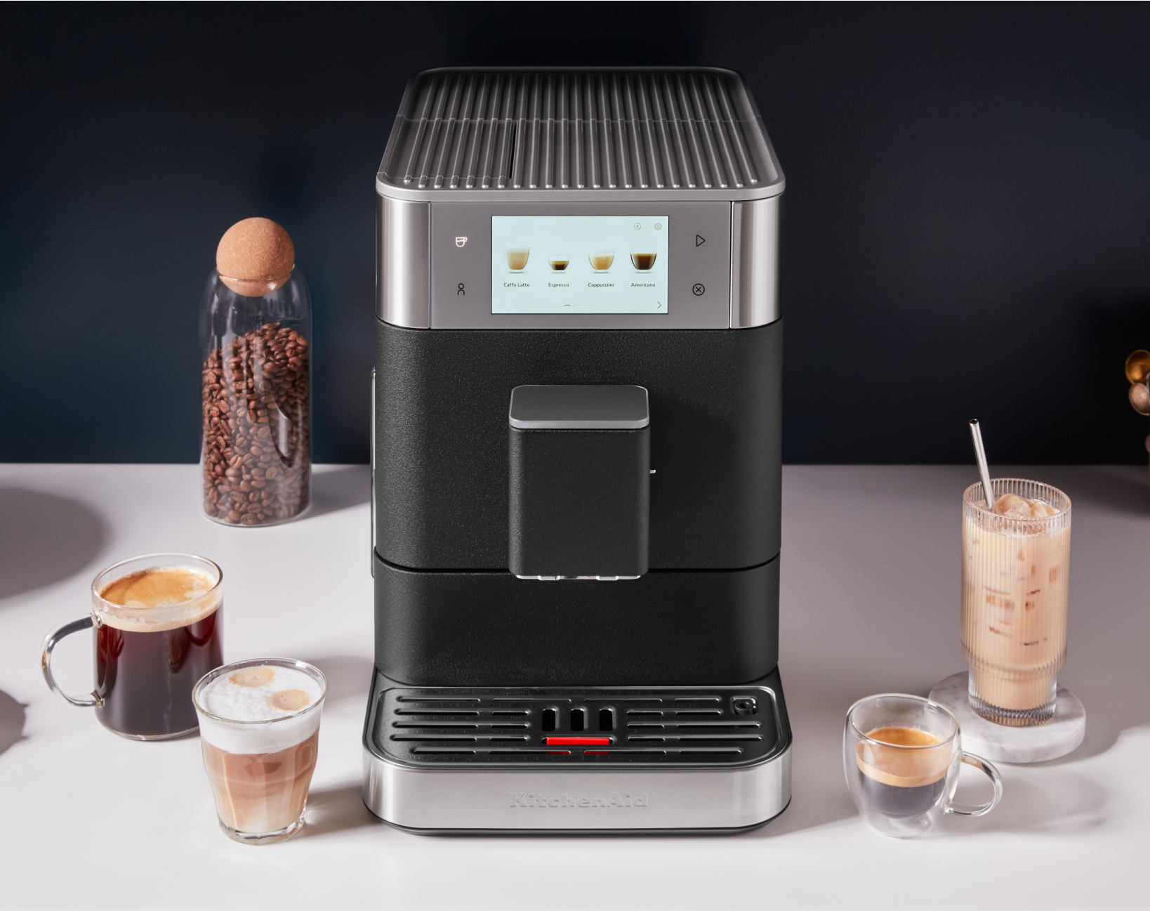 A KitchenAid® espresso machine surrounded by coffee drinks