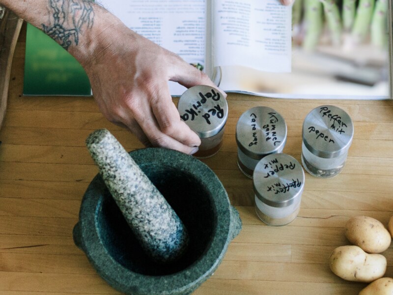 A person adding ingredients to a bowl