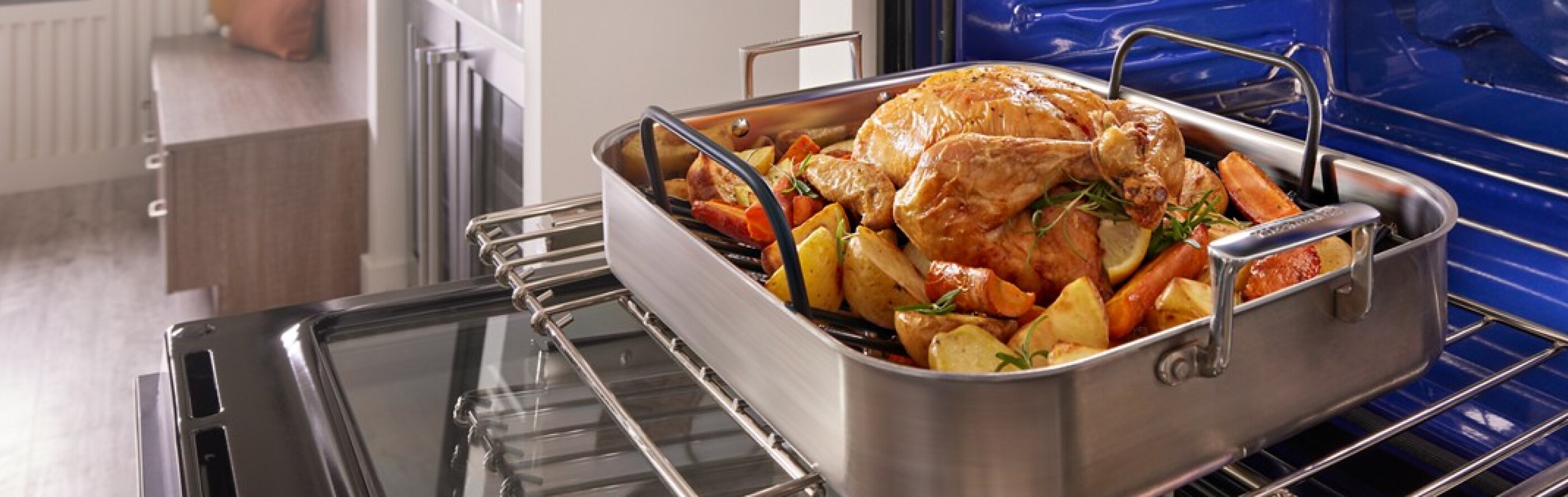 A turkey and vegetables in an air fry basket in a KitchenAid® wall oven