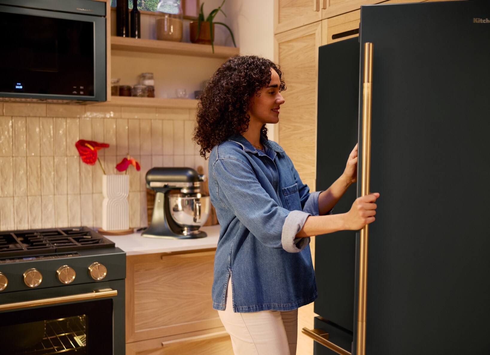 A person opening the door of a refrigerator