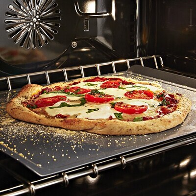 A pizza cooking in an oven