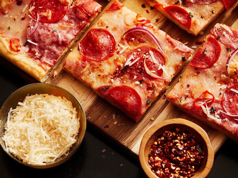 A pizza cut in squares