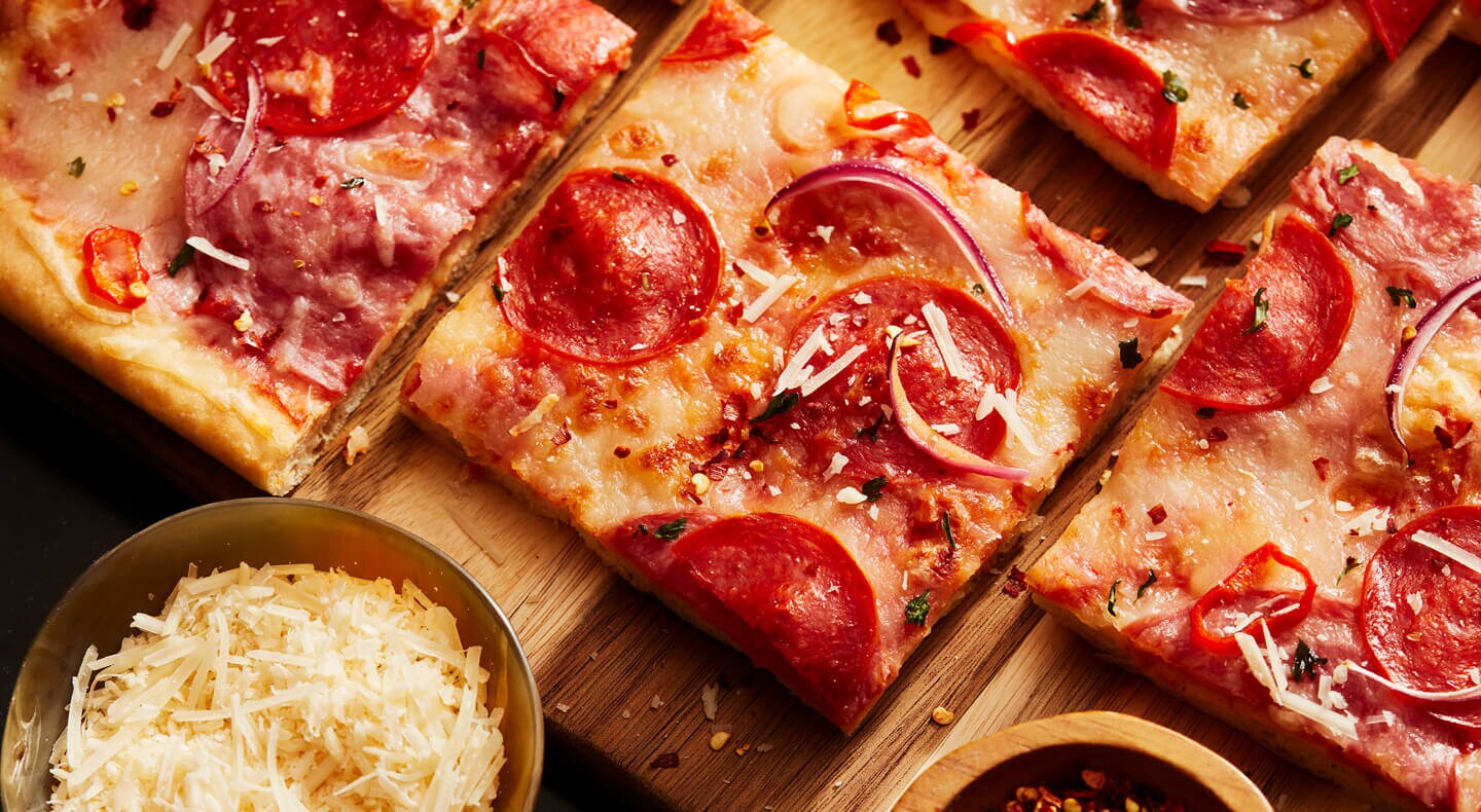 A pizza cut in squares