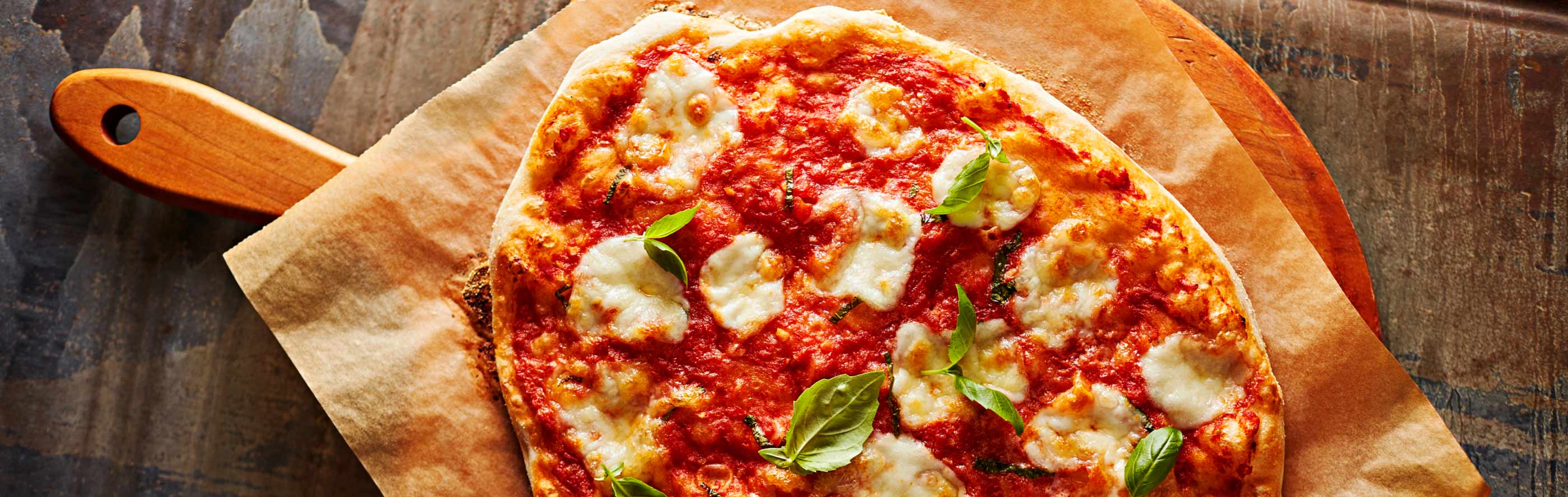 A pizza on a wooden cutting board