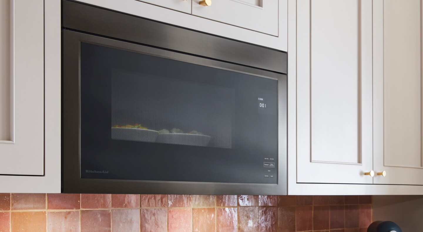 KitchenAid® microwave set in white cabinetry