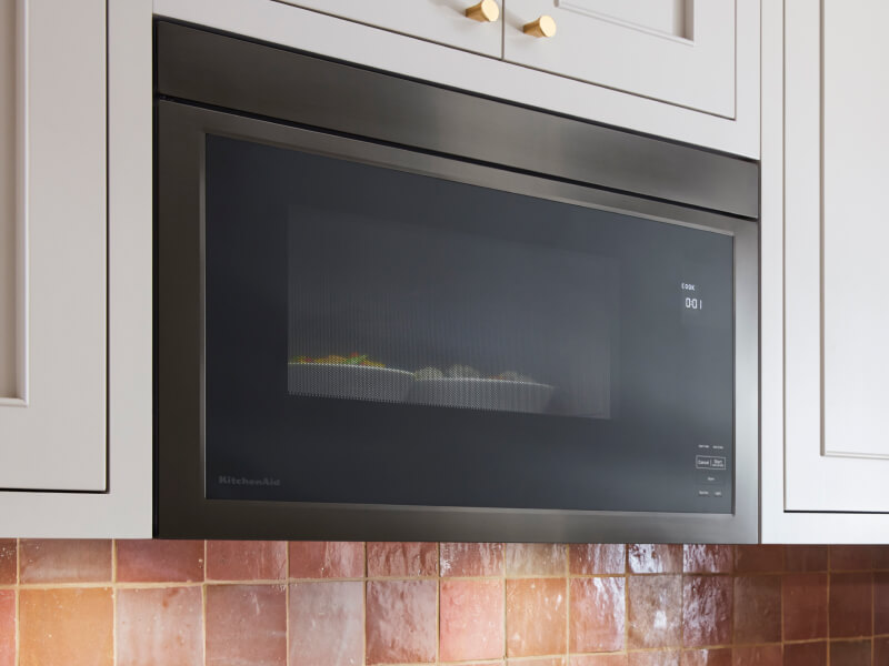 KitchenAid® microwave set in white cabinetry