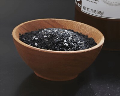 Wooden bowl filled with black salt