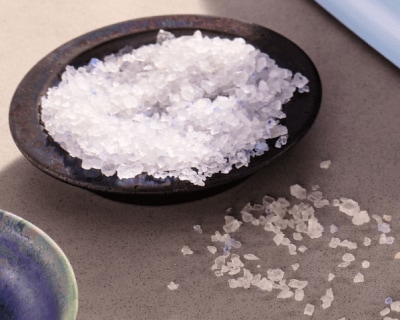 Wooden bowl filled with blue salt