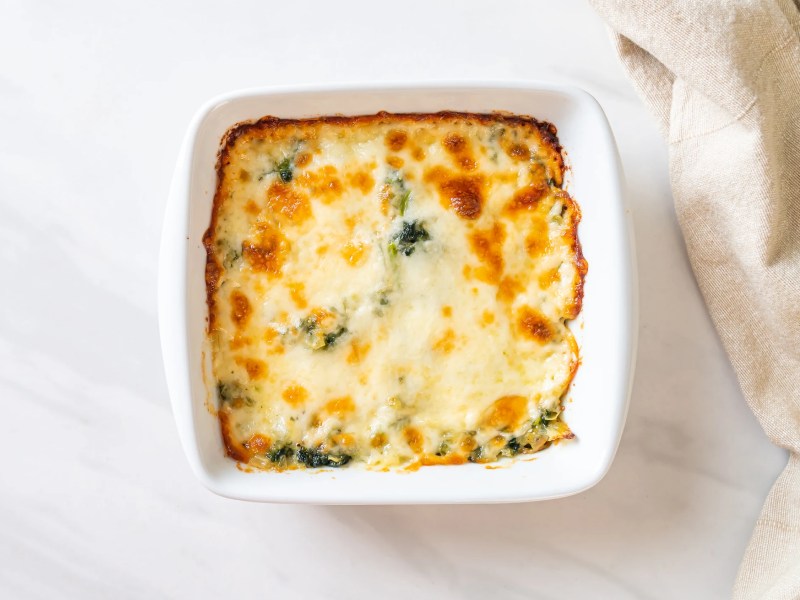 A cheesy-looking dip in a white dish A cheesy-looking dip in a white dish