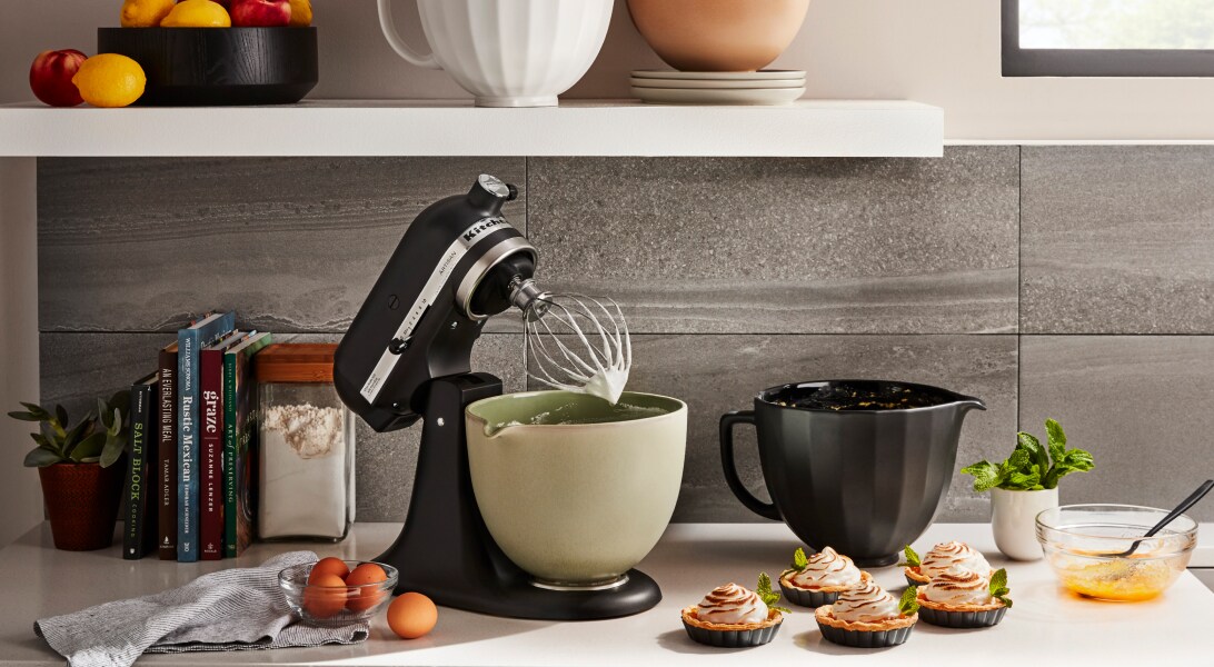 Black KitchenAid® tilt-head stand mixer next to homemade tartes Black KitchenAid® tilt-head stand mixer next to homemade tartes