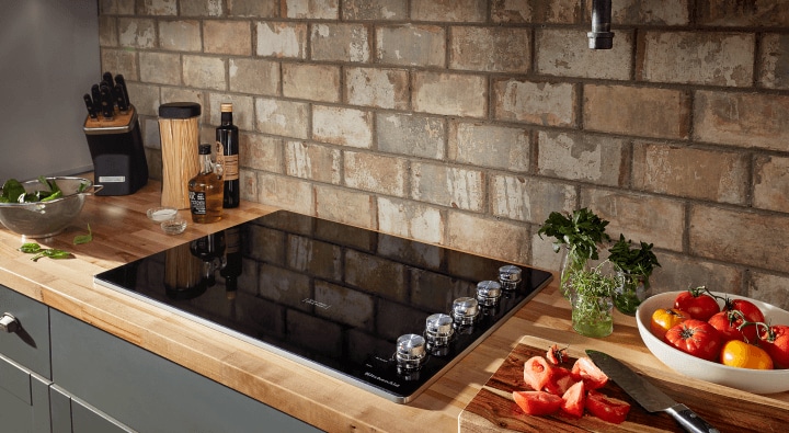 Food being prepared around an electric cooktop