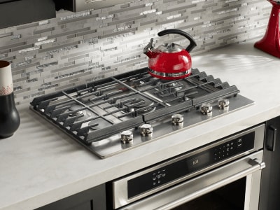 A modern kitchen with a gas cooktop A modern kitchen with a gas cooktop