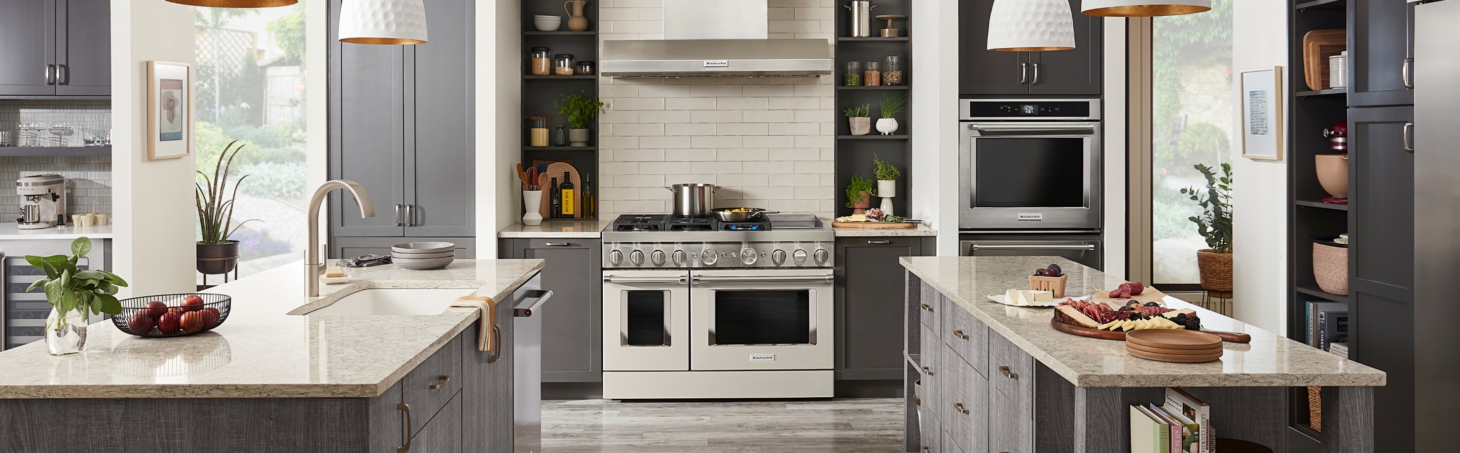 Kitchen with two islands, commercial style range and gray cabinets Kitchen with two islands, commercial style range and gray cabinets