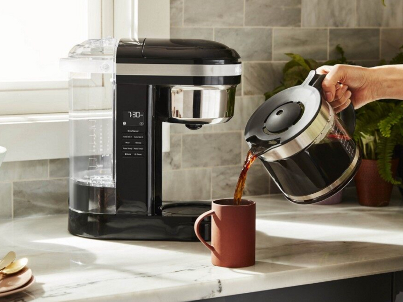 Person pouring from KitchenAid® drip coffee maker