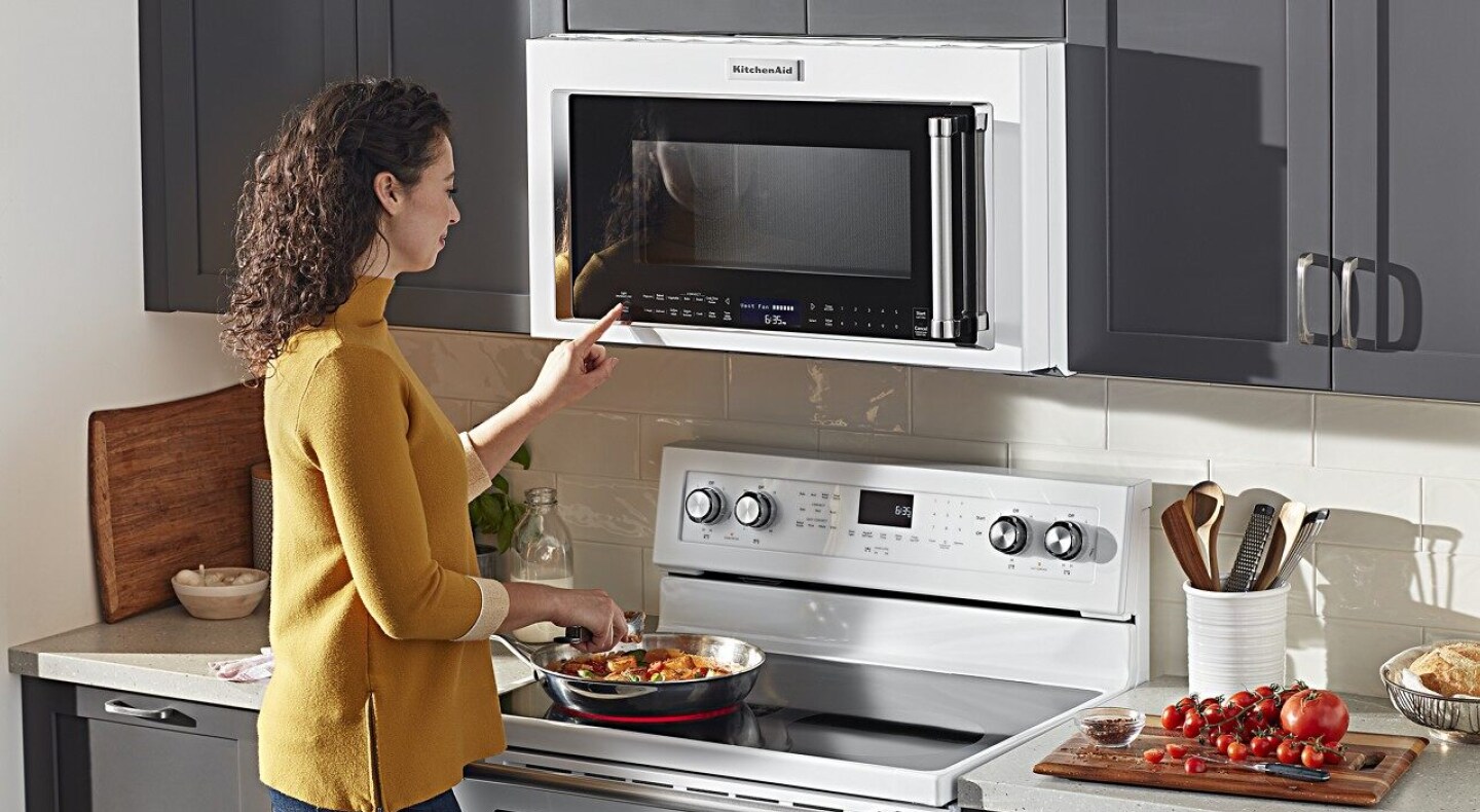 Person selecting a cook setting on a KitchenAid® over-the-range microwave Person selecting a cook setting on a KitchenAid® over-the-range microwave