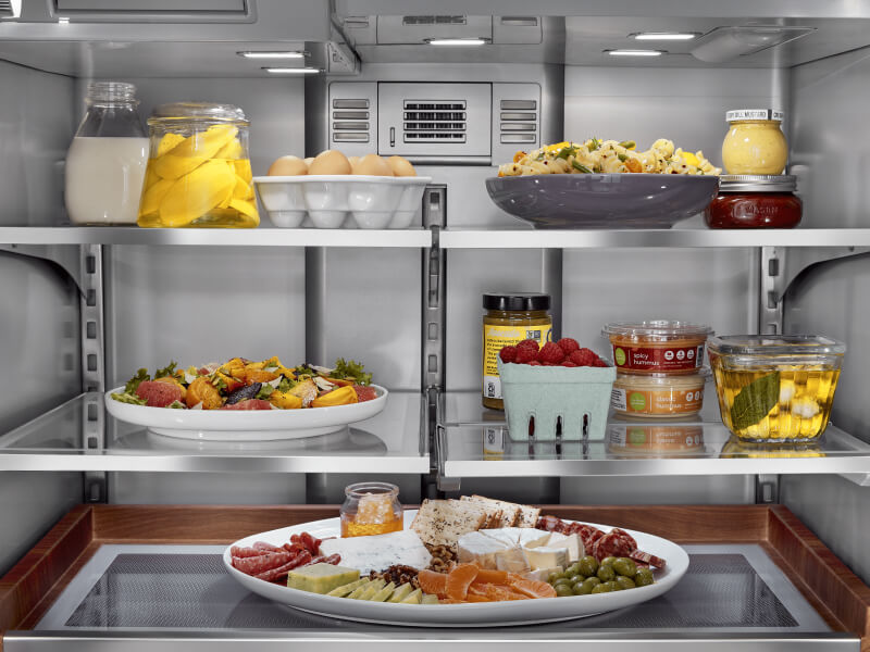 Inside of a KitchenAid® refrigerator with elaborate platters inside