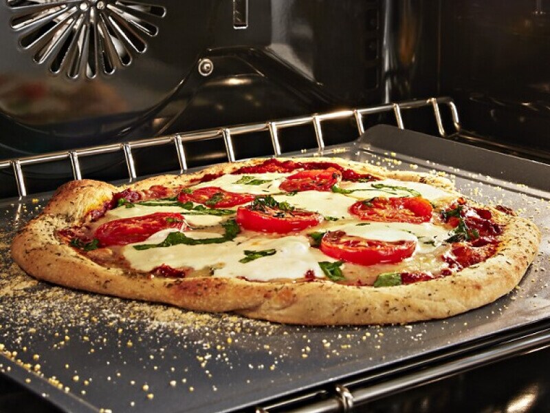  A close up of a pizza baking in an oven