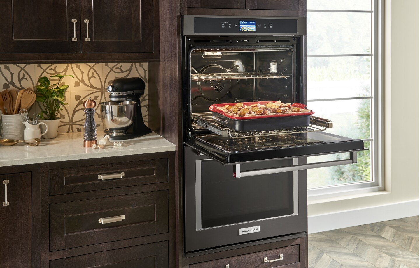 Open KitchenAid® double wall oven with a tray of potatoes on the rack Open KitchenAid® double wall oven with a tray of potatoes on the rack