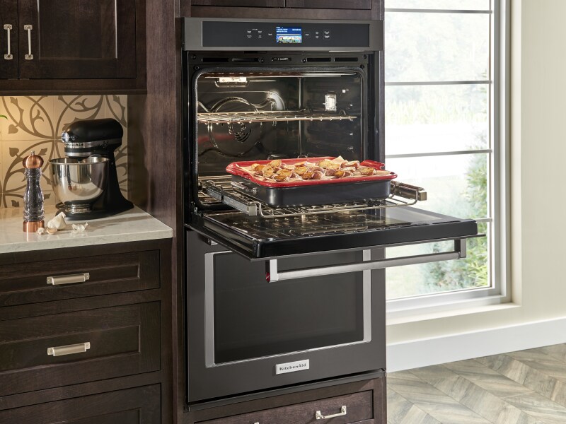 Open KitchenAid® double wall oven with a tray of potatoes on the rack Open KitchenAid® double wall oven with a tray of potatoes on the rack