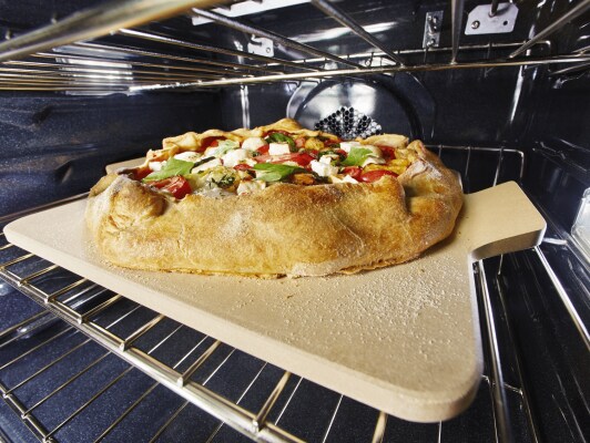 Vegetable tart baking inside an oven