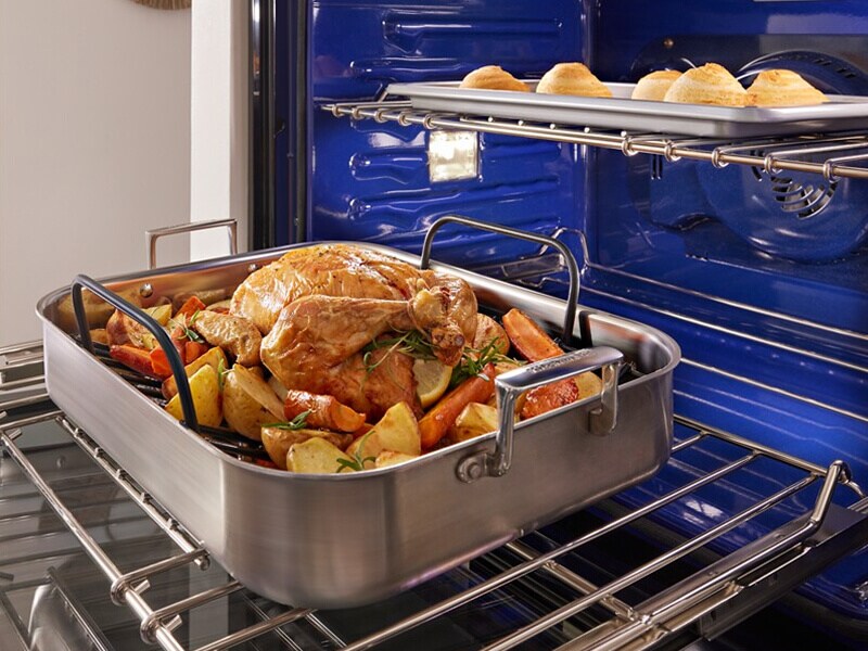 Chicken in a roasting pan inside a wall oven