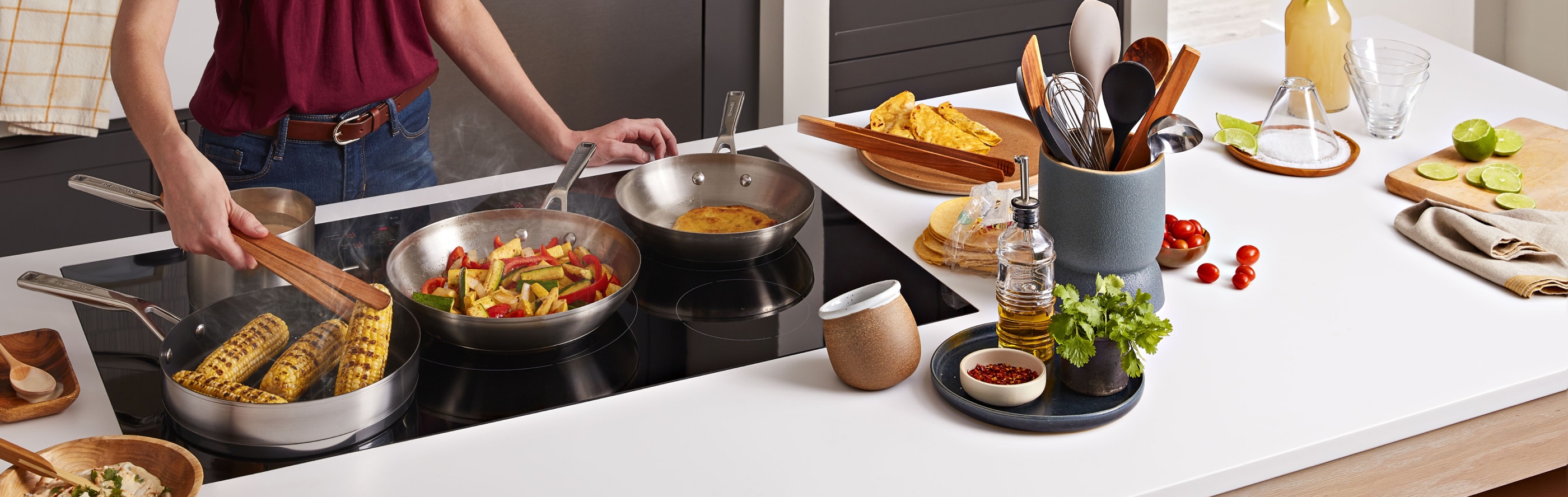 Multiple dishes cooking on a KitchenAid® induction cooktop