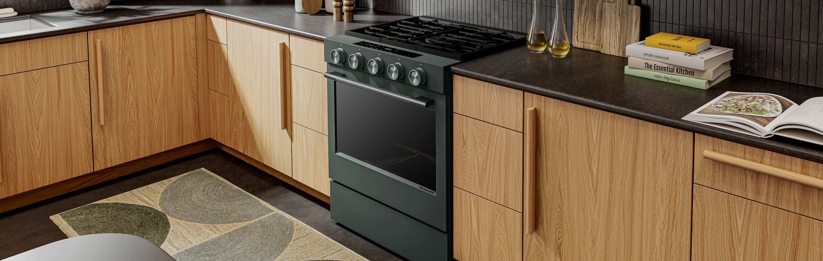 Black Ore KitchenAid® gas range between brown cabinetry