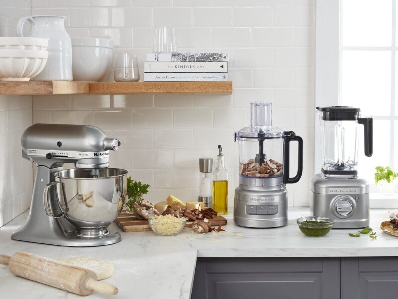 KitchenAid® stand mixer, food processor and blender on countertop with cutting board and ingredients KitchenAid® stand mixer, food processor and blender on countertop with cutting board and ingredients