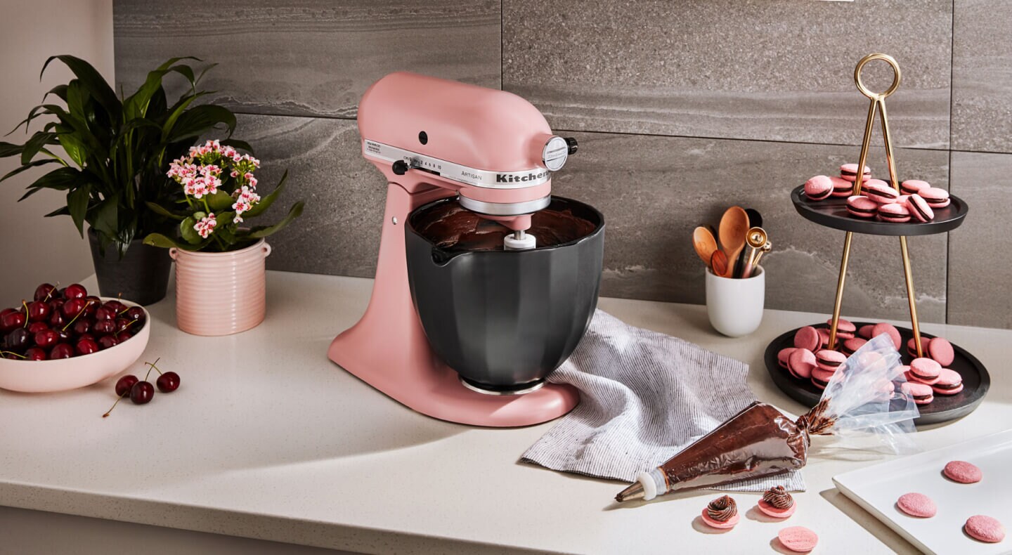 KitchenAid® stand mixer with black bowl next to homemade macaroons KitchenAid® stand mixer with black bowl next to homemade macaroons