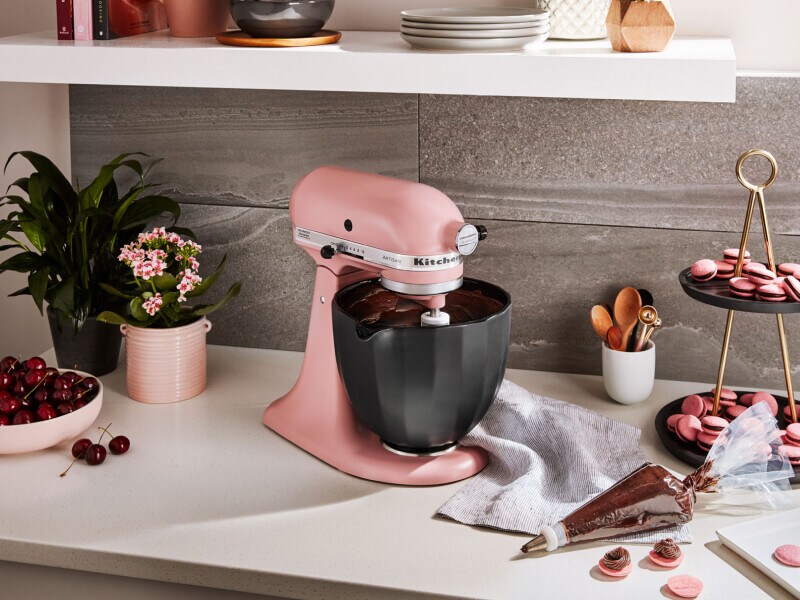 KitchenAid® stand mixer with black bowl next to homemade macaroons KitchenAid® stand mixer with black bowl next to homemade macaroons