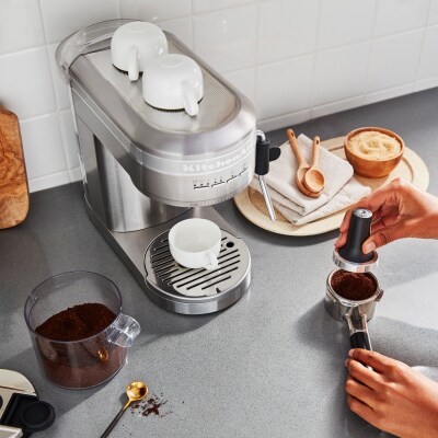 Stainless steel KitchenAid® espresso maker on a gray countertop