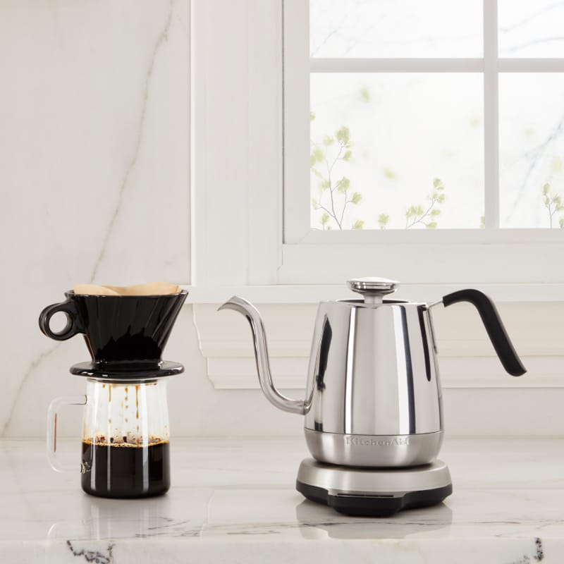 Same as Image Alt Text KitchenAid® electric goose-necked kettle next to a coffee and pastries