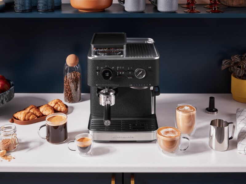 Black KitchenAid® Semi-Automatic Espresso Machine surrounded by espresso drinks Black KitchenAid® Semi-Automatic Espresso Machine surrounded by espresso drinks