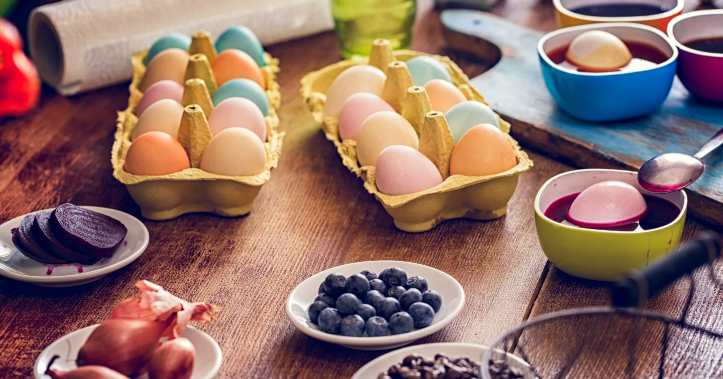 Assortment of dyed eggs, colorful dyes and fresh beets on countertop Assortment of dyed eggs, colorful dyes and fresh beets on countertop