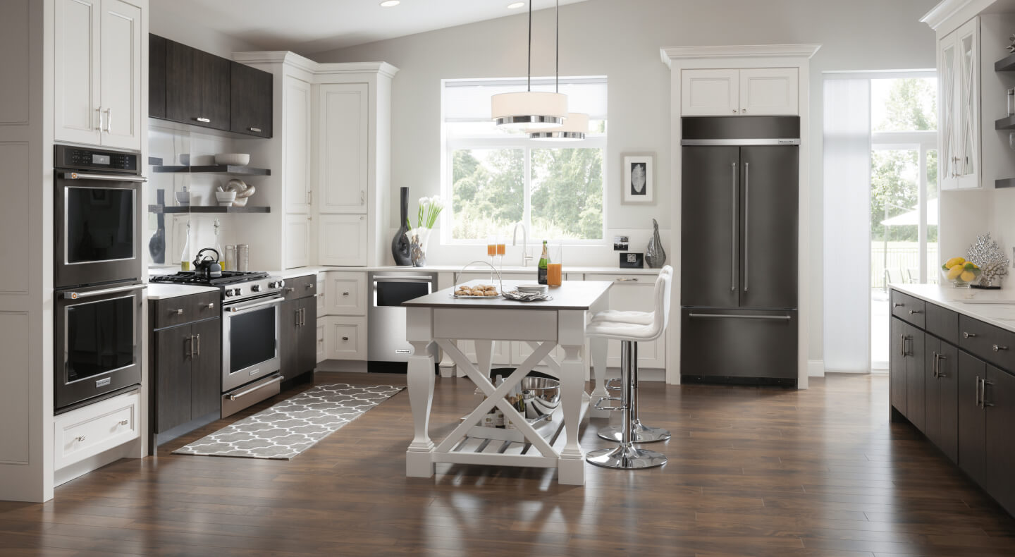 Stainless steel appliances in a bright, open kitchen