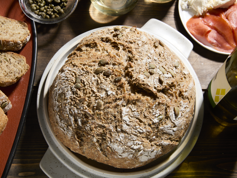 A loaf of homemade bread on a table. A loaf of homemade bread on a table.
