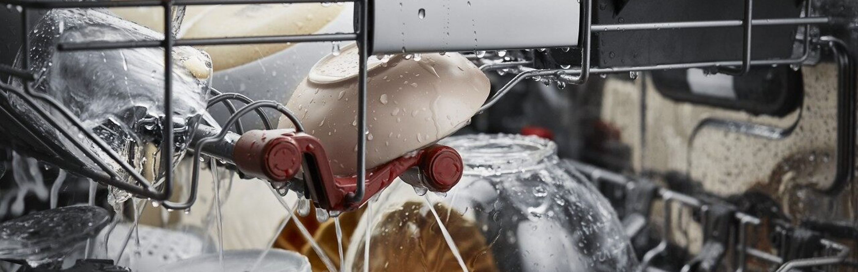 A closeup of the interior of a KitchenAid® dishwasher during a wash cycle.