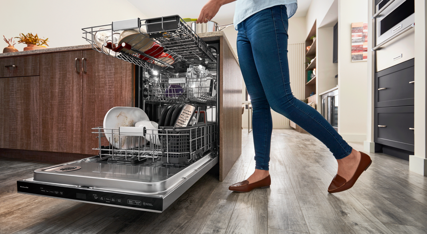 Person loading a dishwasher Person loading a dishwasher