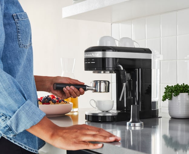 Woman using an espresso maker