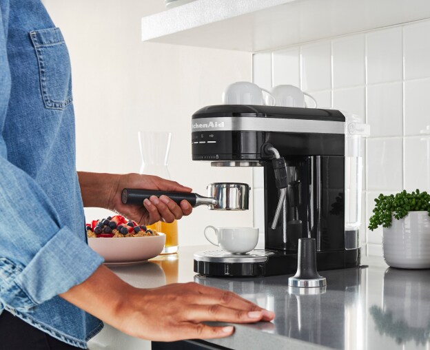 Woman using an espresso maker
