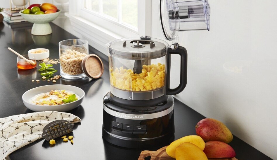 Black KitchenAid® food processor with mango in work bowl Black KitchenAid® food processor with mango in work bowl