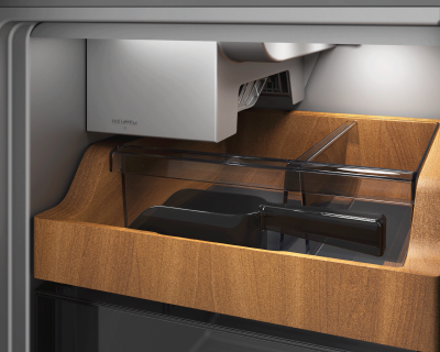 Wood-framed shelving surrounding an empty ice maker