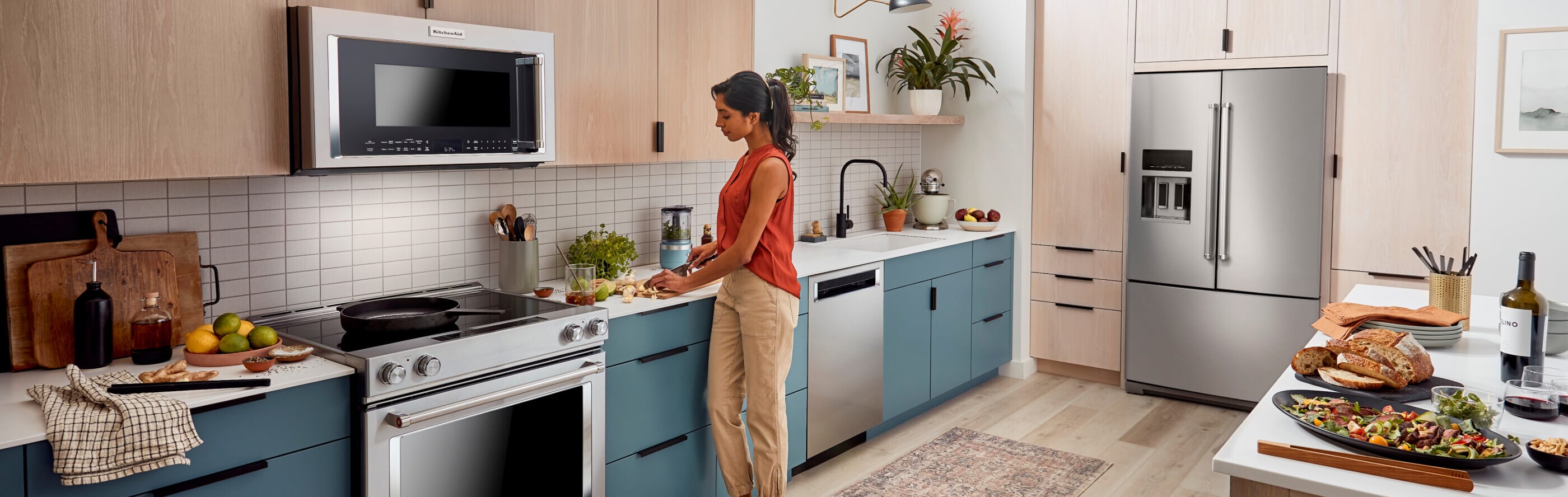 A kitchen with wood cabinets and a french door stainless steel refrigerator