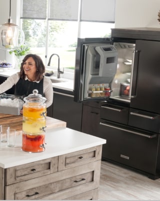 Open Black French door refrigerator in a modern kitchen