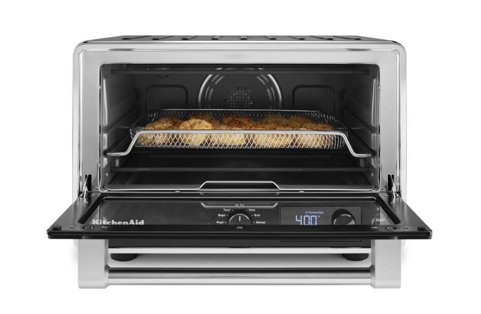 View of an open KitchenAid® countertop oven with food inside View of an open KitchenAid® countertop oven with food inside