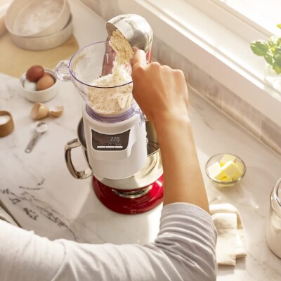 A person measuring flour