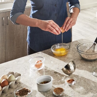 Cracking eggs into a bowl