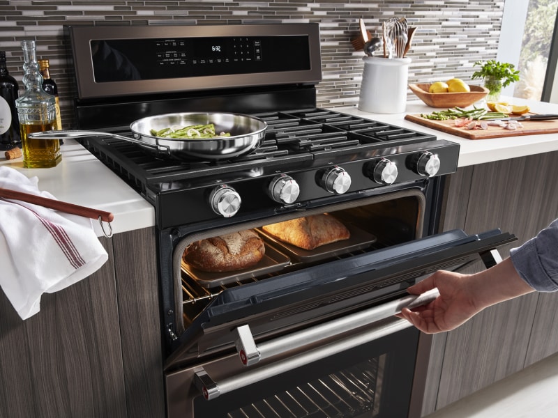 Woman cooking in gas oven