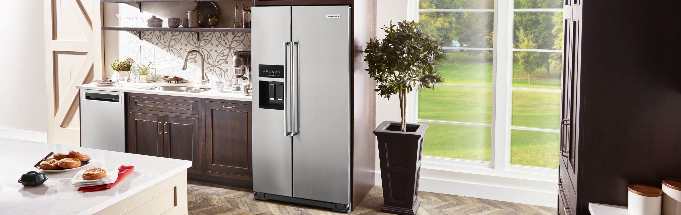 KitchenAid® side-by-side refrigerator in brown cabinetry