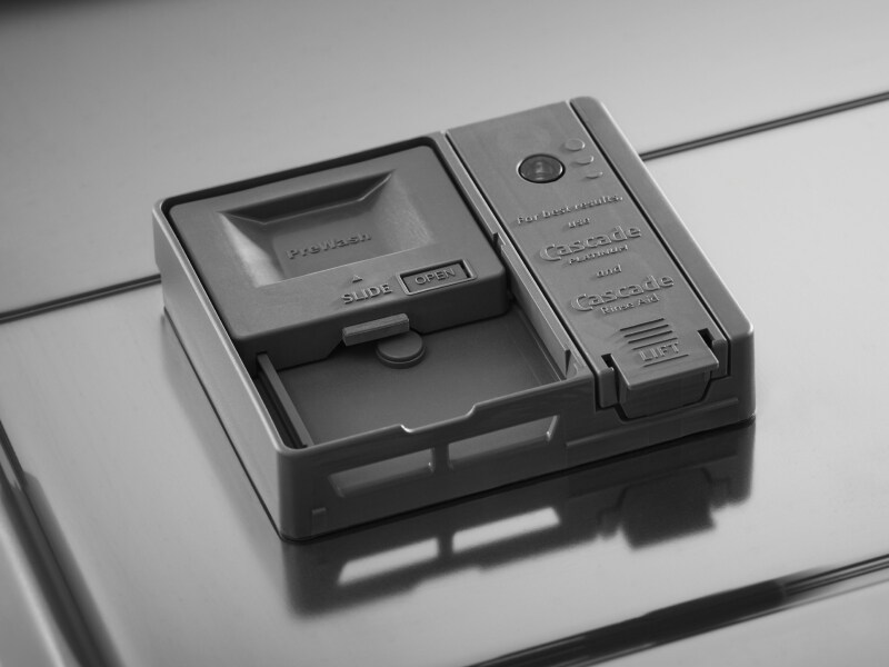 The detergent dispenser of a KitchenAid® dishwasher.